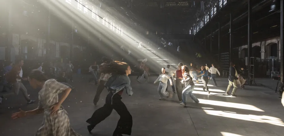 Los bailarines danzan. rayos de luz entran por las ventanas.