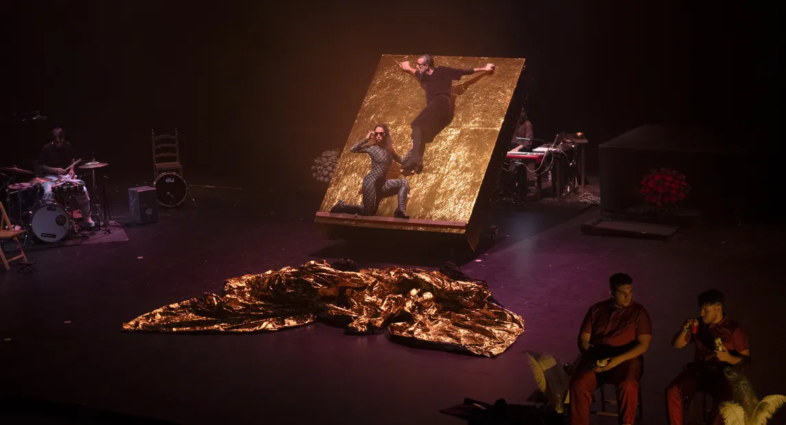 Two dancers present their show standing on a platform.