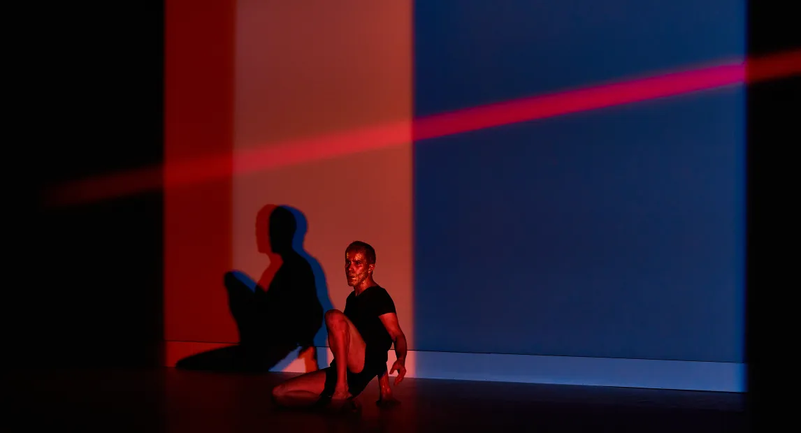 Un bailarín esta sentado, una luz roja