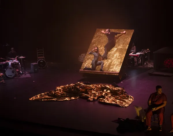 Two dancers present their show standing on a platform.