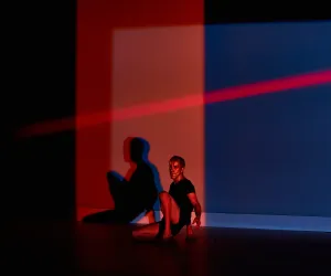 marcos G punto Un bailarín esta sentado, una luz roja